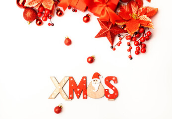 Merry Christmas or New Year background with red gift boxes, fir branches, Christmas balls, berries, stars and inscription Xmas