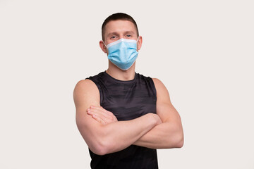 Sportsman Wearing Medical Mask. Man Hands Crossed with Mask. Healthy Life, Medical protection, Sports Concept. Sport