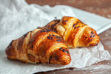 Fresh Baked Croissants on wood background.