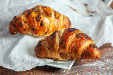 Fresh Baked Croissants on wood background.