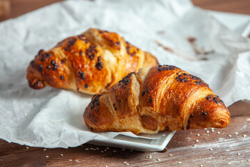 Fresh Baked Croissants on wood background.