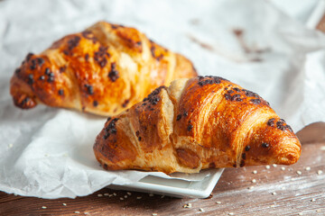 Fresh Baked Croissants on wood background.