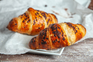 Fresh Baked Croissants on wood background.