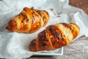 Fresh Baked Croissants on wood background.