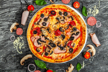 Fototapeta na wymiar Pizza Quatro stagione with tomato sauce, salami, mushrooms, mozzarella, bacon, olives.