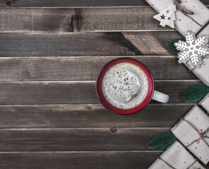 Cup of hot drink, new Year's gift, on a dark wooden background. Christmas card. Top view.Copy space.