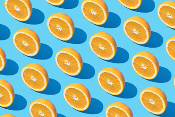 Seamless pattern of yellow slices of oranges with shadows on blue background