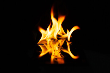 fire flame with reflection in the glass on a black background