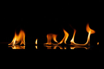 fire flame with reflection in the glass on a black background