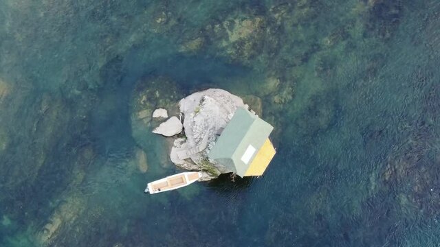 Small wooden cabin on a rock in the middle of river Drina, Serbia.	
