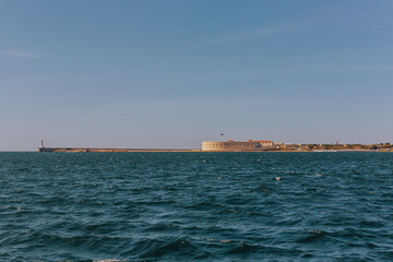 Konstantinovskaya battery, and a pier with a lighthouse at the exit from Sevastopol Bay in the Black sea