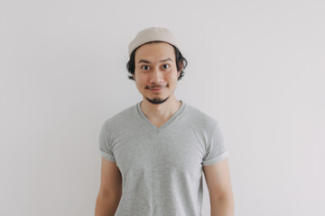 Long hair and beard Asian man in grey t-shirt and cap isolated on white.