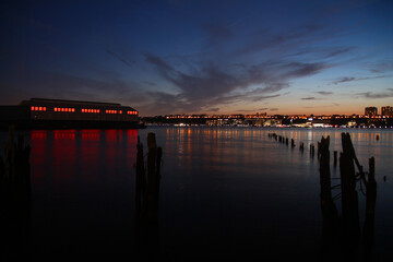 The red lighted pier and the river during the sunset