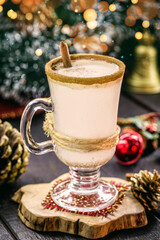 glass of hot eggnog, Christmas drink, based on eggs, cinnamon, almonds and rum liqueur. called eggnog