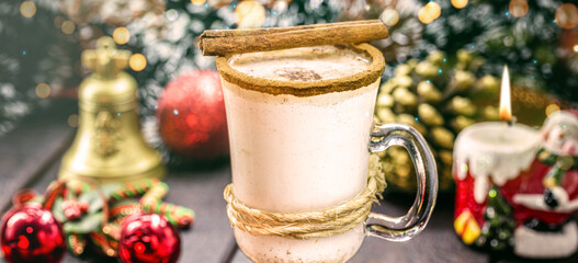 glass of hot eggnog, Christmas drink, based on eggs, cinnamon, almonds and rum liqueur. called...