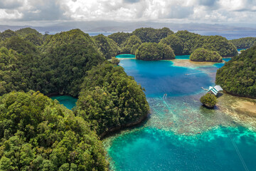 Aerial shot a Limestone islands form a remote lagoon in northern Raja Ampat, Indonesia.