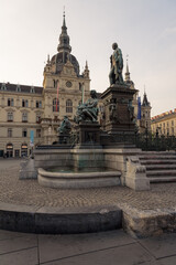 Fototapeta na wymiar Main square of Graz with the Fountain of Archduke Erzherzog-Johann-Brunnen and the Renaissance-style Town Hall in the background, Styria, Austria