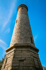 Myles Standish Monument on blue sky background, low angle view close-up.