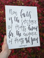 Bible verse calligraphy hand lettering on a canvas with red fall foliage in the background 