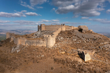 Ruins of the ancient Greek fortress Larisa with stone walls and towers on a top of a hill