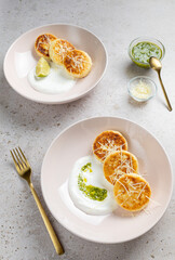 Unsweetened cottage cheese fritters served with greek yogurt, pesto sauce and parmesan. Traditional Russian pancakes - syrniki. Healthy breakfast.