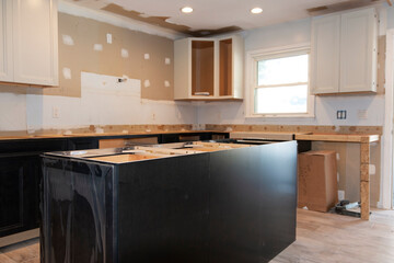 New cabinets and island being installed in a kitchen