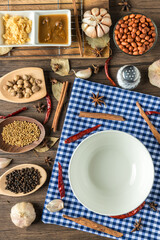 White Circle Dish and Ingredients and spices on background. Healthy cooking concept. empty circle white dish on wooden background.	