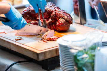 Roast pork neck. Roasted shoulder of pork on a cutting board.