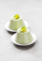 Italian dessert, Avocado Panna Cotta on a plate on a light gray background