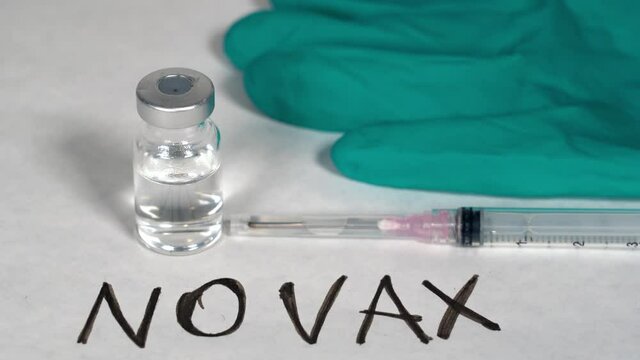 Generic vial without logo of vaccine against Covid-19 Coronavirus epidemic - vaccination and syringe - no vax people doctor 