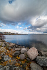 Barrie waterfront centennial park  lakeshore  path with green grass and fall colour trees   blue sky with broken clouds 