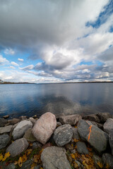 Barrie waterfront centennial park  lakeshore  path with green grass and fall colour trees   blue sky with broken clouds 