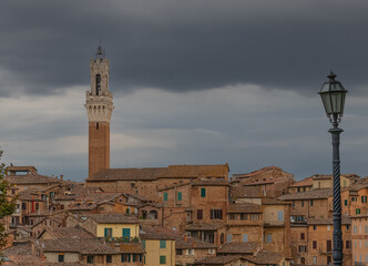 Panoramic View over Siena with Torre del Mangia in Evening light with dramatic Sky, Siena, italy