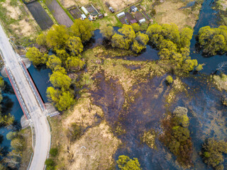 A small bridge over beautiful river in a field near the forest. Summer landscape. top view