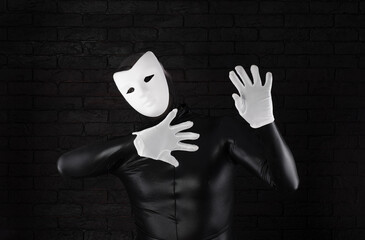 funny mime in a white mask on a black background