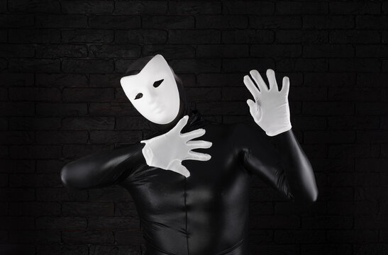 funny mime in a white mask on a black background