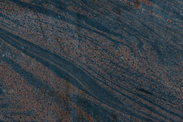 Background with a texture of natural stone. A slice of granite with a beautifully colored texture and veins. Stone for interior decoration. The beauty of natural materials in home decor