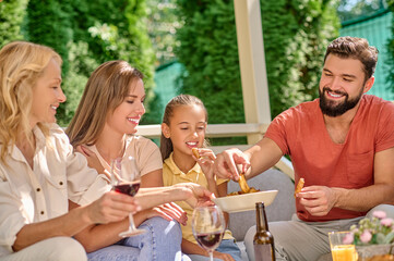 A smiling family sitting at the dinner table