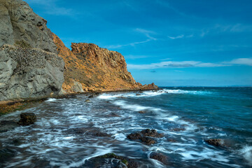 Fototapeta na wymiar Waves and long exposure on the cliffs of Bozcaada coast