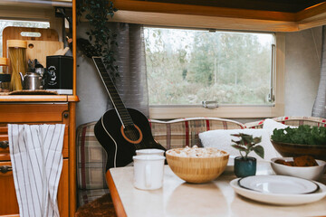 cozy kitchen interior in the trailer of mobile home or recreational vehicle, concept of family local travel in native country on caravan or camper van and camping life