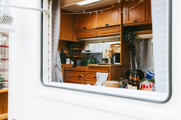 cozy kitchen interior in the trailer of mobile home or recreational vehicle, concept of family local travel in native country on caravan or camper van and camping life