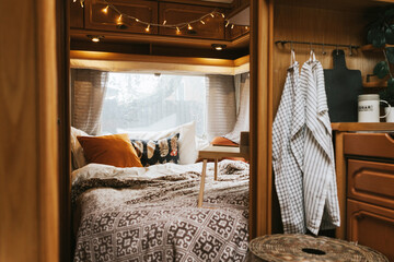 cozy bedroom interior in the trailer of mobile home or recreational vehicle, concept of family...