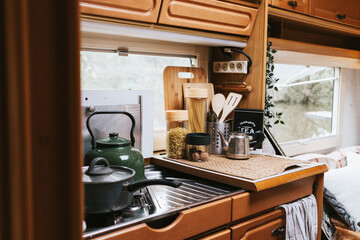 cozy kitchen interior in the trailer of mobile home or recreational vehicle, concept of family local travel in native country on caravan or camper van and camping life