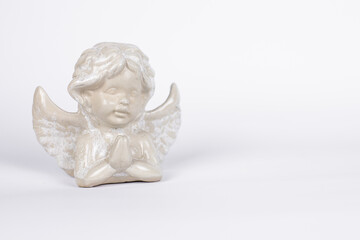 statuettes of angels on a white background