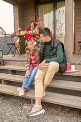 Dad sitting with his daughter on the steps of the house