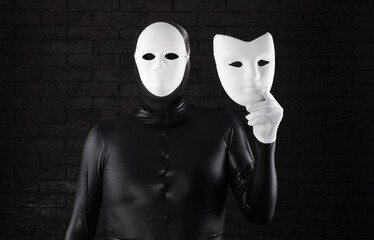 two-faced man in a white mask on a black background