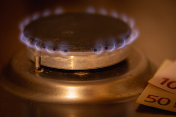 Gas is burning in the kitchen. There is money nearby. Growth in gas prices.