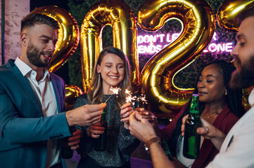 Happy group of friends celebrate New Year's Eve in a club