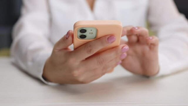Close up of female hands holding smartphone. Female enjoy online chat, internet purchase, browse web, download new cool freeware application. Modern wireless tech user concept