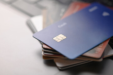 Deposit and credit cards on an open laptop. Shopping, online shopping, credit purchases, bonuses, discounts, sales. Close-up. There are no people in the photo. Color image.